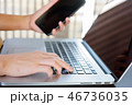 Closeup woman hand working on laptop and mobile  46736035