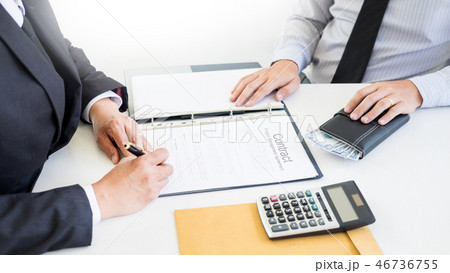 Businessman receive money in the envelope offered in file taking Businessman receive money in the envelope offered in file taking 46736755