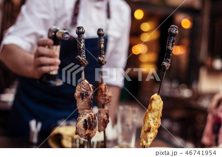 Meat on skewer fry with a cooking gas torch flomber. 46741954