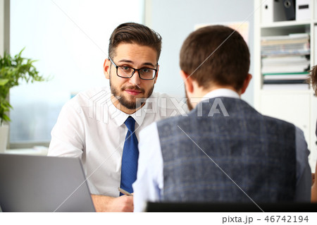 Two smiling clerk businessmen deliberate on problem Two smiling clerk businessmen deliberate on problem 46742194