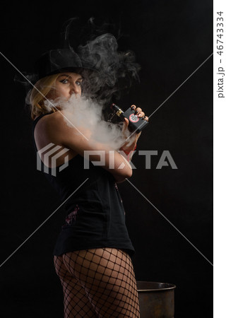 Young sexy woman is vaping.  46743334
