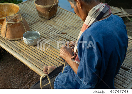 Hands of old man makes traditional basket Hands of old man makes traditional basket 46747743