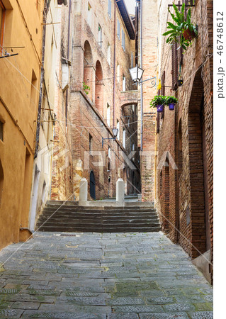 Medieval narrow street in Siena, Tuscany, Italy. Medieval narrow street in Siena, Tuscany, Italy. 46748612