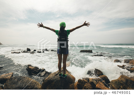 woman enjoying nature opened arms on seaside woman enjoying nature opened arms on seaside 46749301