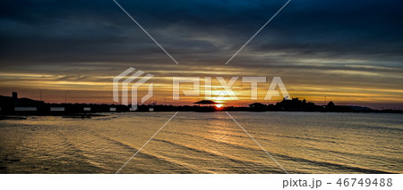 Sunset sky at sea with silhouette of bridge and is 46749488
