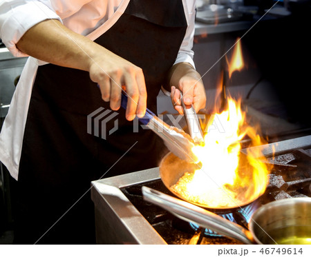 Chef cooking food in the kitchen, preparing food 46749614