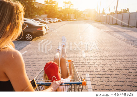 The girl carries her friend in a basket The girl carries her friend in a basket 46749928