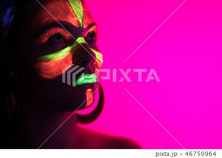 Fashion sexy dancer in neon light. Fluorescent makeup glowing under ultraviolet light. Night club Fashion sexy dancer in neon light. Fluorescent makeup glowing under ultraviolet light. Night club 46750964