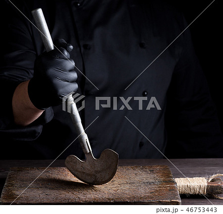 chef  holds in his hand a metal old knife 46753443