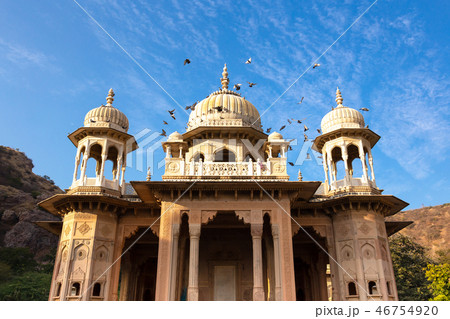 Royal Gaitore Tumbas in Jaipur India with bird flying over in blue sky. Royal Gaitore Tumbas in Jaipur India with bird flying over in blue sky. 46754920