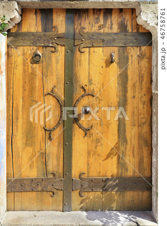 Antique wooden doors with forged handles rungs. Antique wooden doors with forged handles rungs. 46758761