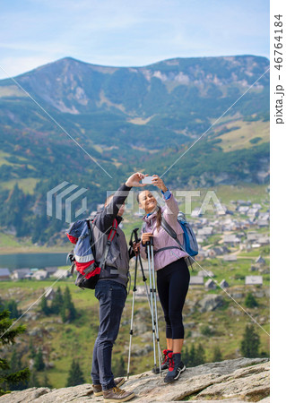 Two hikers taking selfie on top of the mountain 46764184