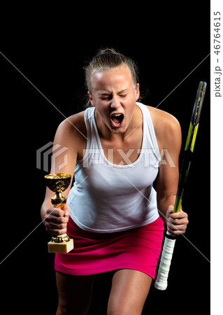Beautiful girl tennis player with a racket on dark background wiht lights celebrating flawless 46764615