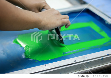 Hand pressing silk-screen printing, close up view. Hand pressing silk-screen printing, close up view. 46770396
