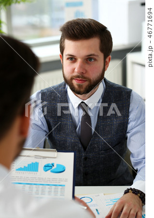 Group of businessmen with financial graph and silver pen 46771694