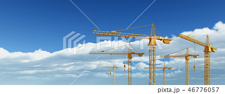 Construction cranes against a blue sky with clouds 46776057