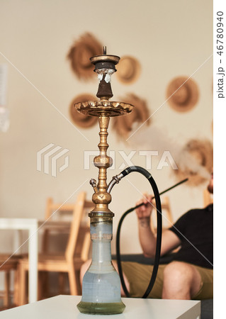 Man smoking hookah 46780940