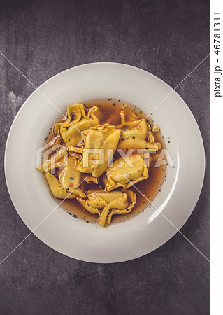 Homemade tortellini in broth in a top view 46781311