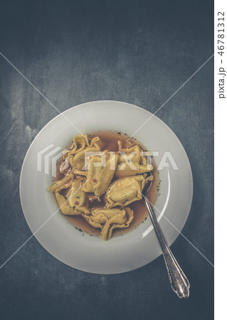Homemade tortellini in broth in a top view 46781312