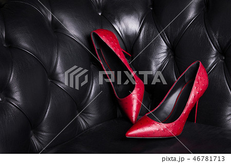 Two red leather shoes on a dark background. Two red leather shoes on a dark background. 46781713