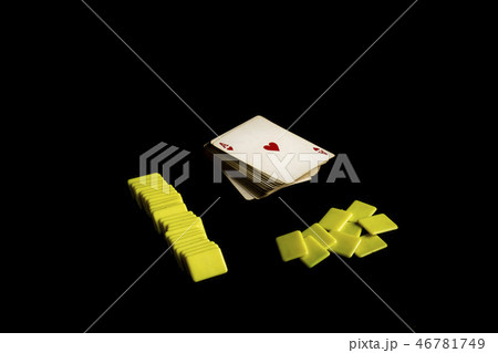 deck of poker cards next to colored plastic chips 46781749