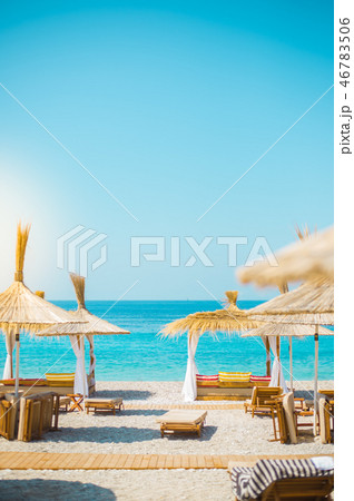 Sunshade umbrellas and deckchairs on the beautiful beach in Himara, Albania. 46783506