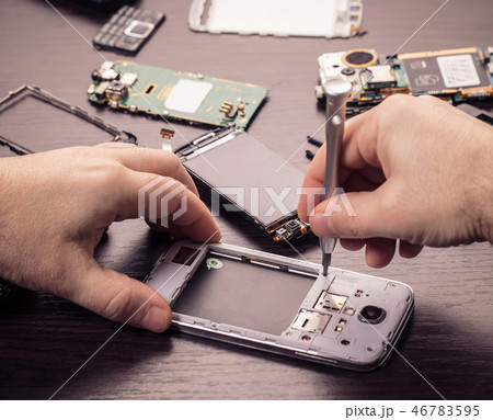 mobile phone repair, hands closeup 46783595