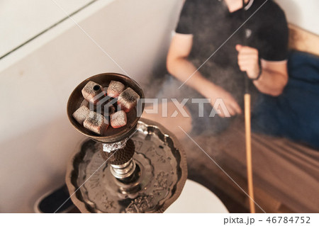 Man smoking hookah 46784752
