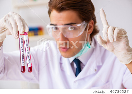 Young handsome lab assistant testing blood samples in hospital Young handsome lab assistant testing blood samples in hospital 46786527