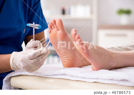 Podiatrist treating feet during procedure 46786573