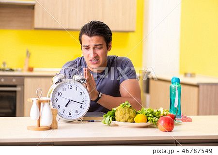 Young man in dieting and healthy eating concept Young man in dieting and healthy eating concept 46787549