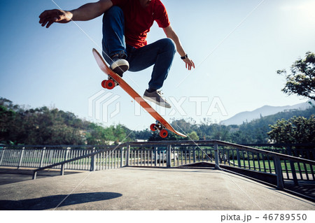 Skateboarder skateboarding at skatepark ramp 46789550