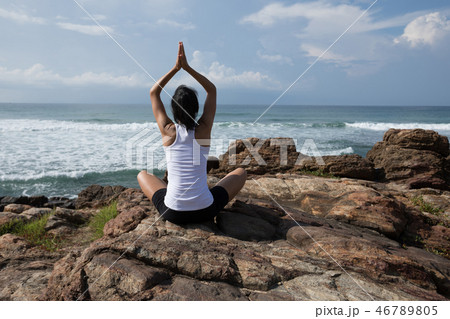 Yoga woman meditation at the seaside cliff edge 46789805