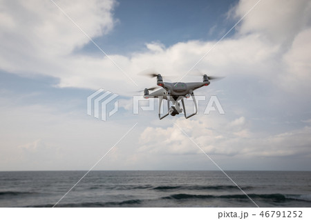 Flying drone which taking photo over sea 46791252