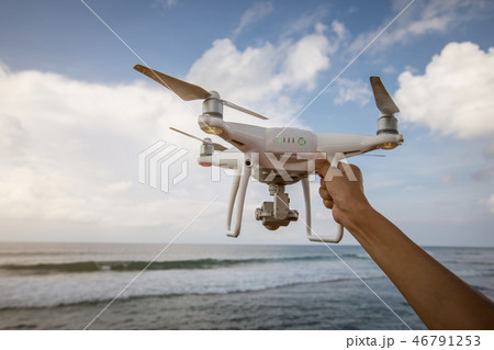 Hand hold drone on seaside 46791253