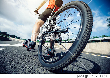 Woman cyclist riding Mountain Bike on highway 46791434