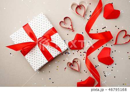 Gift box with red bow ribbon and red origami 46795168