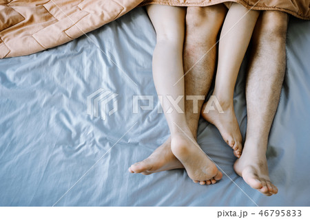 Asian couple in the bedroom on holiday morning. Asian couple in the bedroom on holiday morning. 46795833