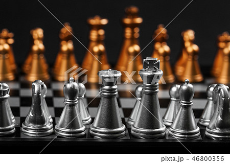 Abstract background. Gold and silver chess on black background. Abstract background. Gold and silver chess on black background. 46800356