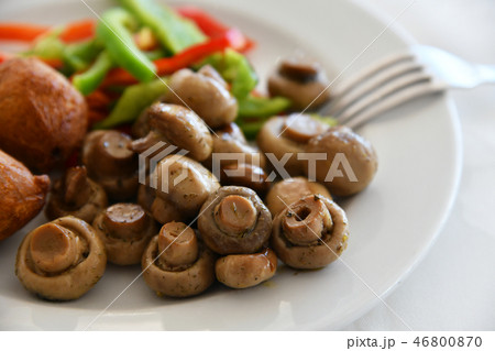 Fried mushrooms and a vegetables on plate 46800870