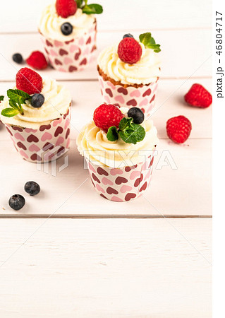 summer dessert of cupcakes and berries, food 46804717
