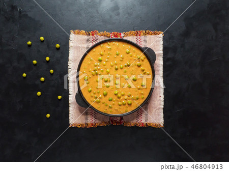 Baked green peas in curry sauce. Indian dish. Baked green peas in curry sauce. Indian dish. 46804913