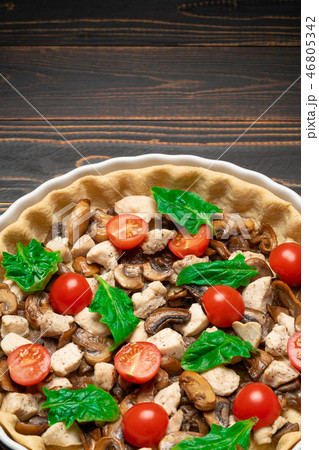 Traditional quiche tart in baking form with filling 46805342