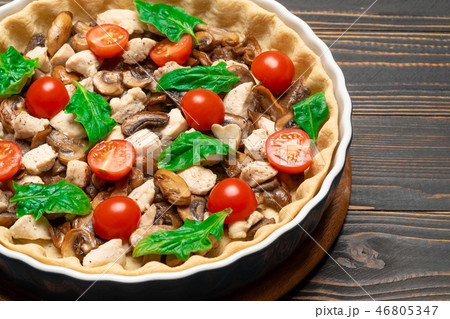 Traditional quiche tart in baking form with filling 46805347