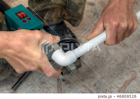 PPR pipes fusion welding, hands working closeup. PPR pipes fusion welding, hands working closeup. 46809526