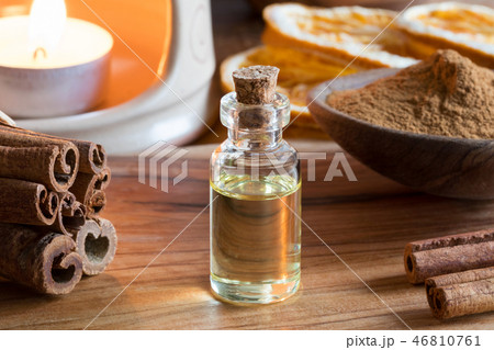 A bottle of cinnamon essential oil with cinnamon 46810761