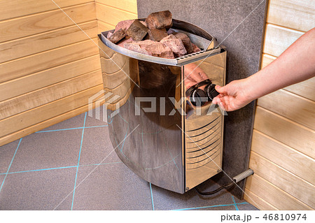 Hand regulates control panel electric stove heater Hand regulates control panel electric stove heater 46810974