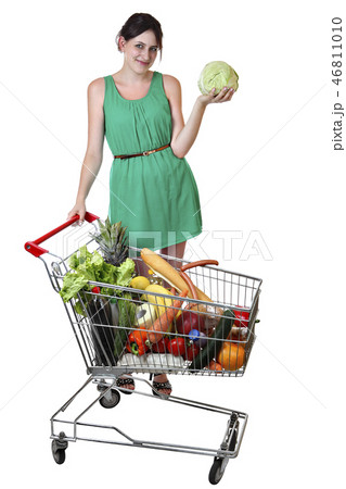 Girl holding cabbage standing near shopping cart. Girl holding cabbage standing near shopping cart. 46811010