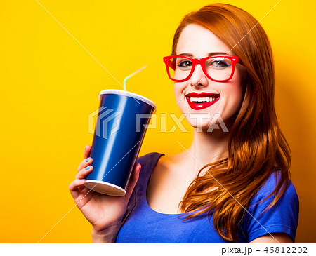 girl in blue dress and glasses with drink girl in blue dress and glasses with drink 46812202