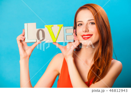 Happy redhead woman with word Love Happy redhead woman with word Love 46812943